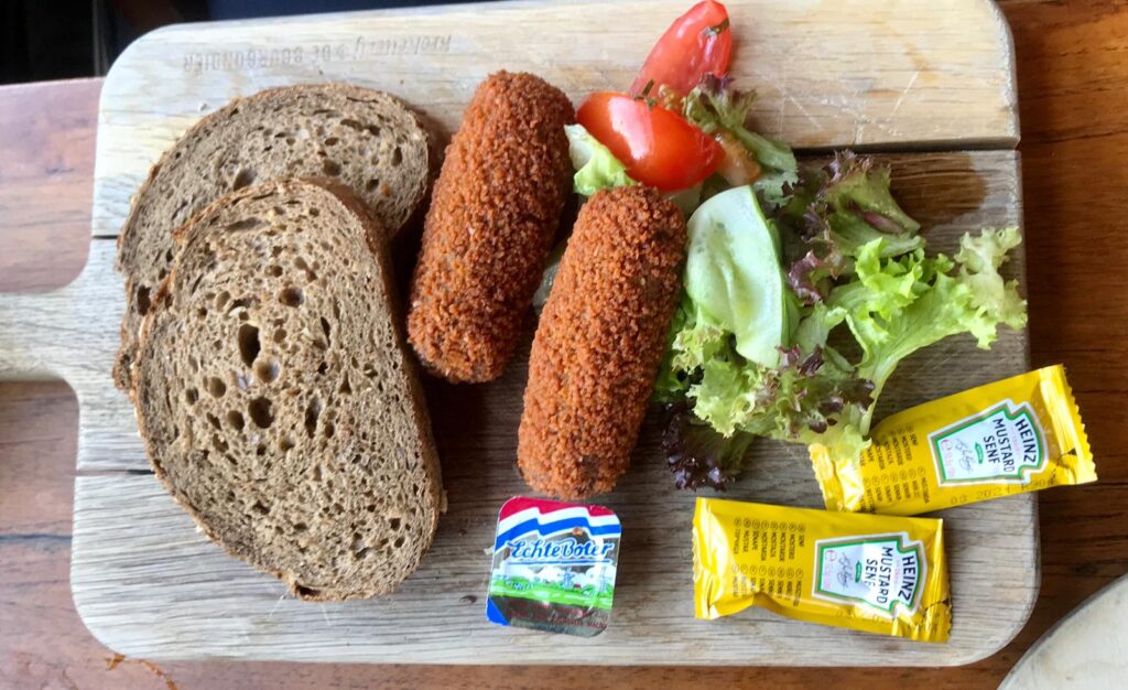 Kroketten with bread, and salad, mustard and butter