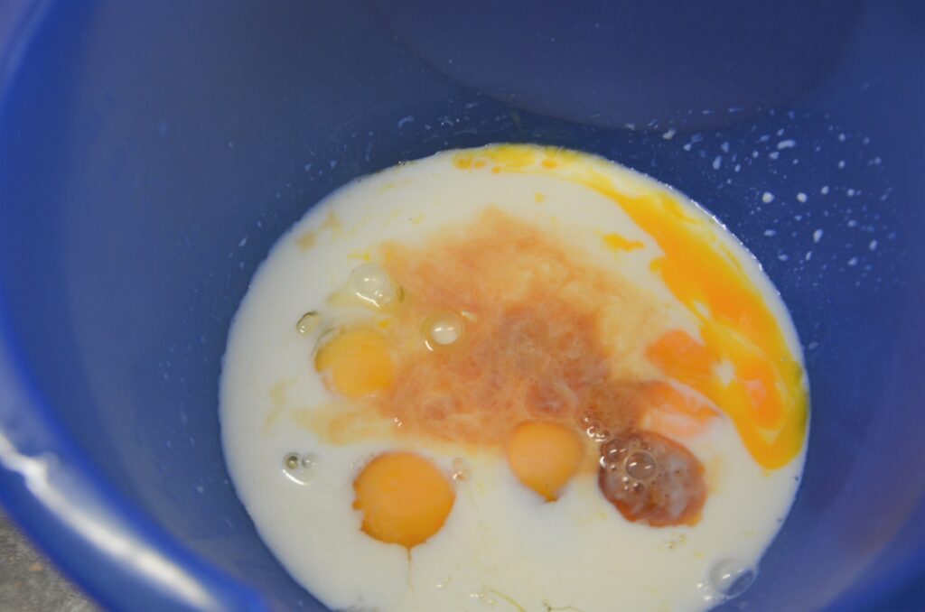 Wet ingredients for the pancake in a blue bowl