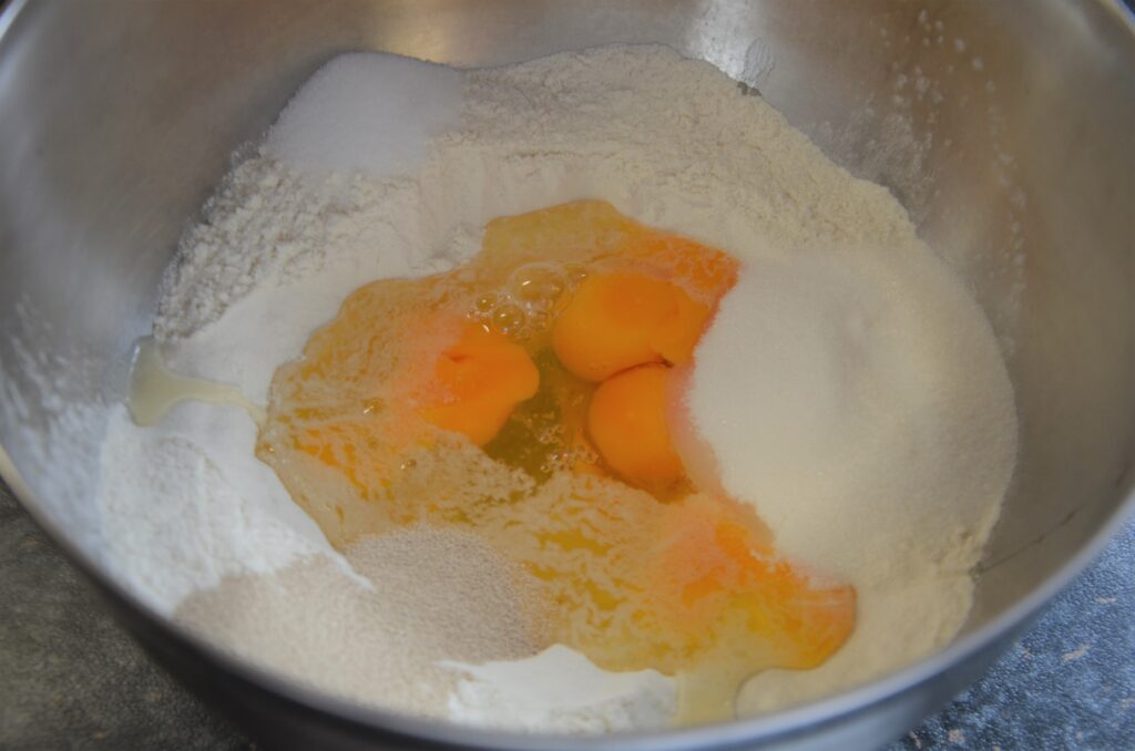 Everything in a bowl, flour, eggs, yeast, salt and sugar in a rvs bowl