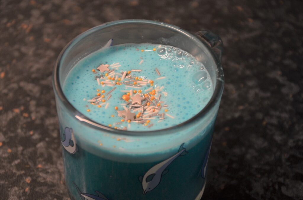 Blue Latte, served in a glass with dolphins on it