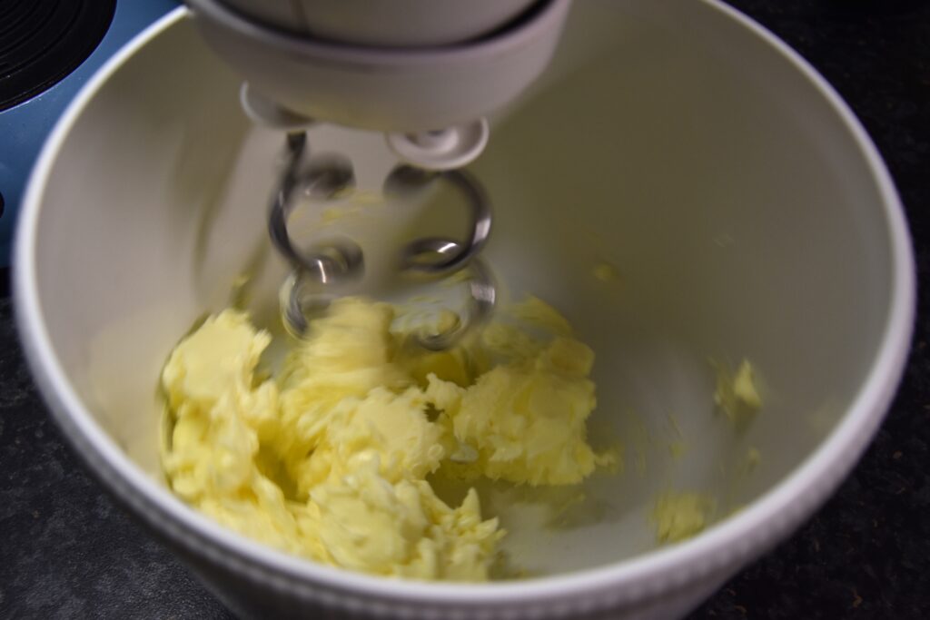 Creaming the butter, in a white bowl