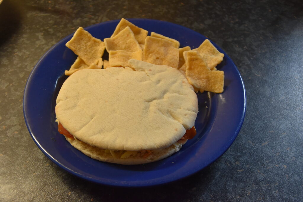 Ham-Pineapple Burger, served on a blue plate with cassava crackers