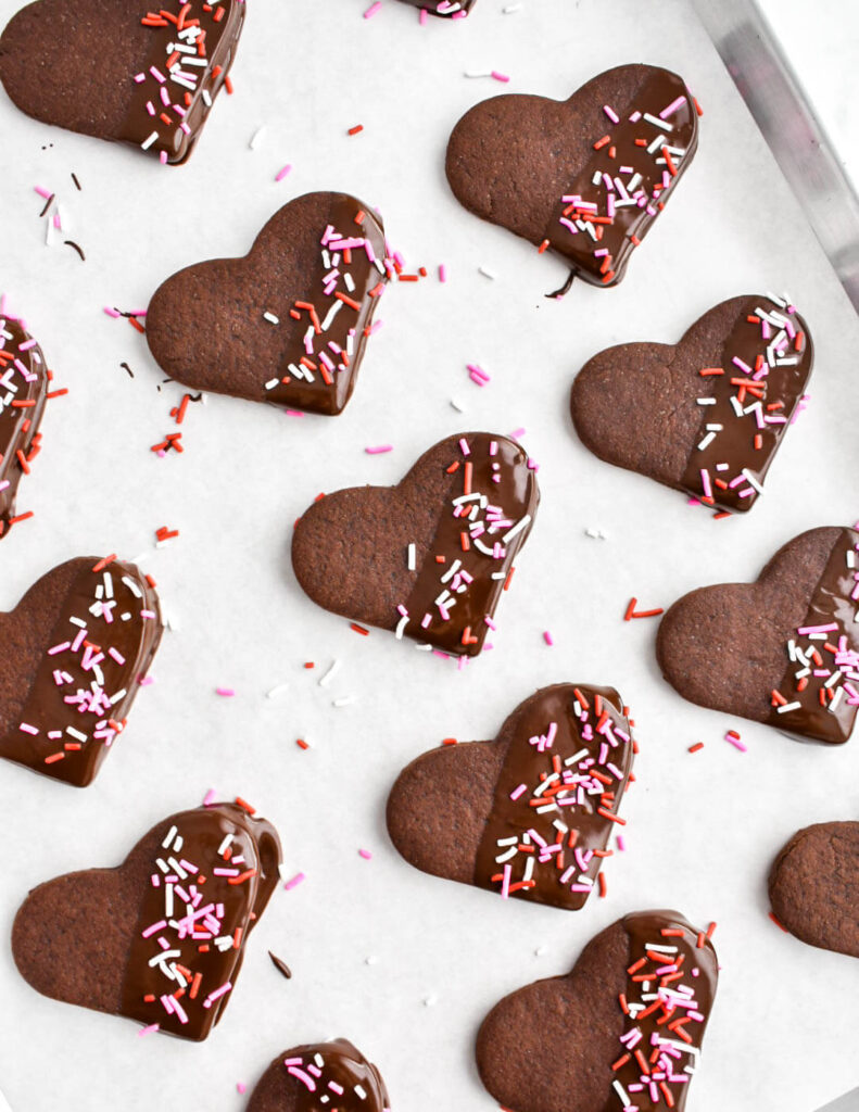 Chocolate Sugar Cookies by Herbs & Flour, heart shaped cookies lined on baking paper